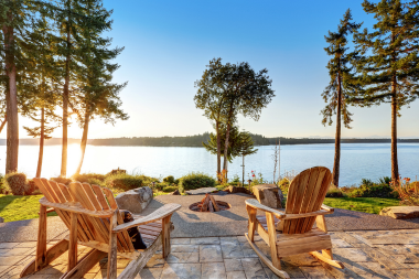 fire pit area designs for your northern michigan backyard lakeside outdoor living space with fireplace and adirondack chairs custom built boyne city