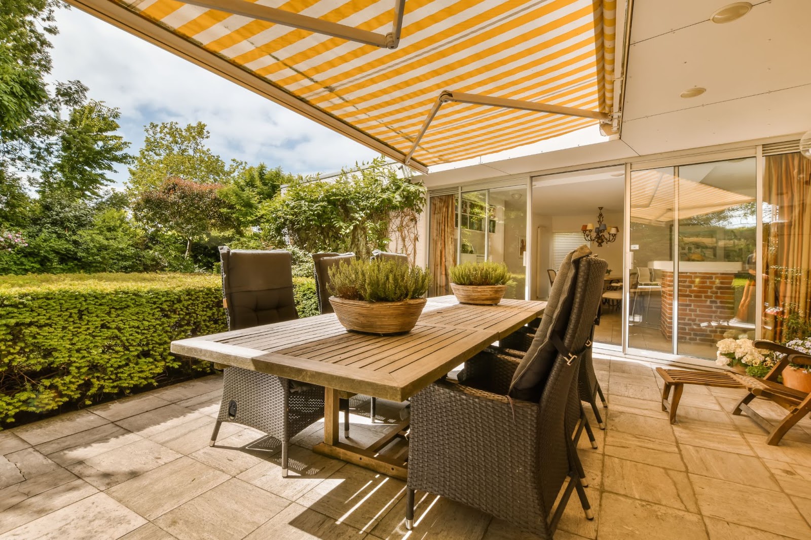 Awning over an outdoor dining area at a home. 