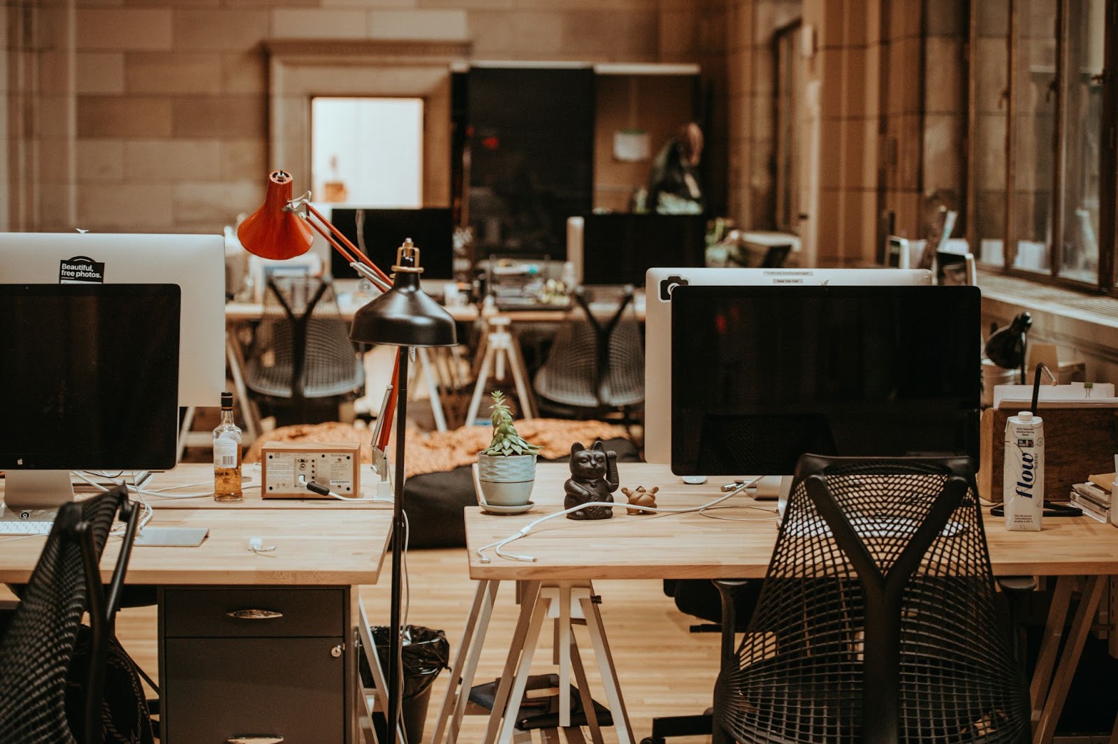 Empty office space with desks and desktop computers