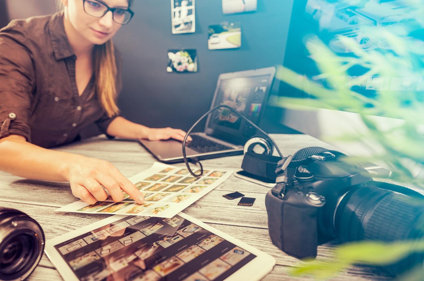 A person sitting at a desk looking at a photo album

Description automatically generated