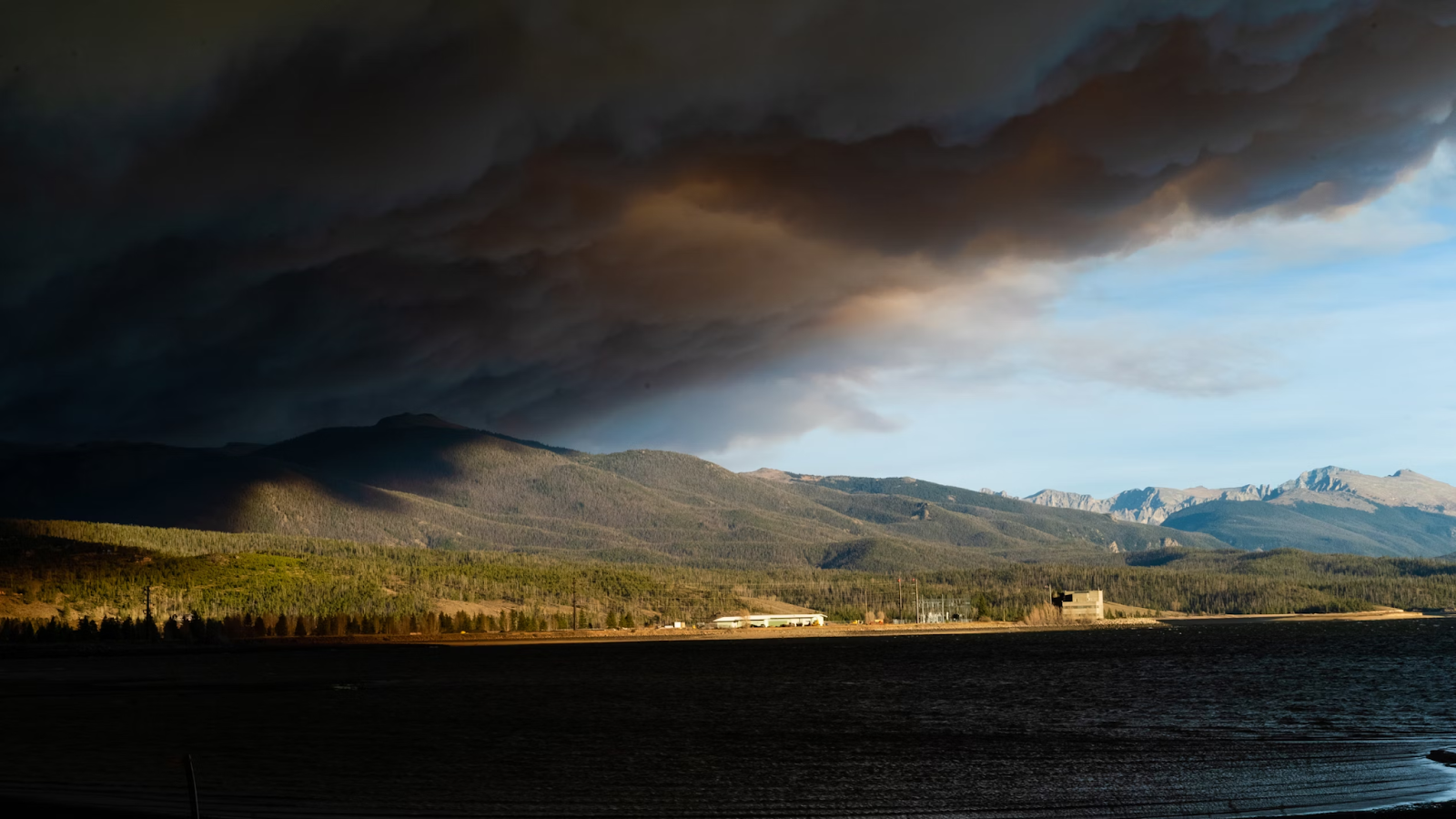 Smoke from the East Troublesome Fire blankets Lake Granby at sunset. 