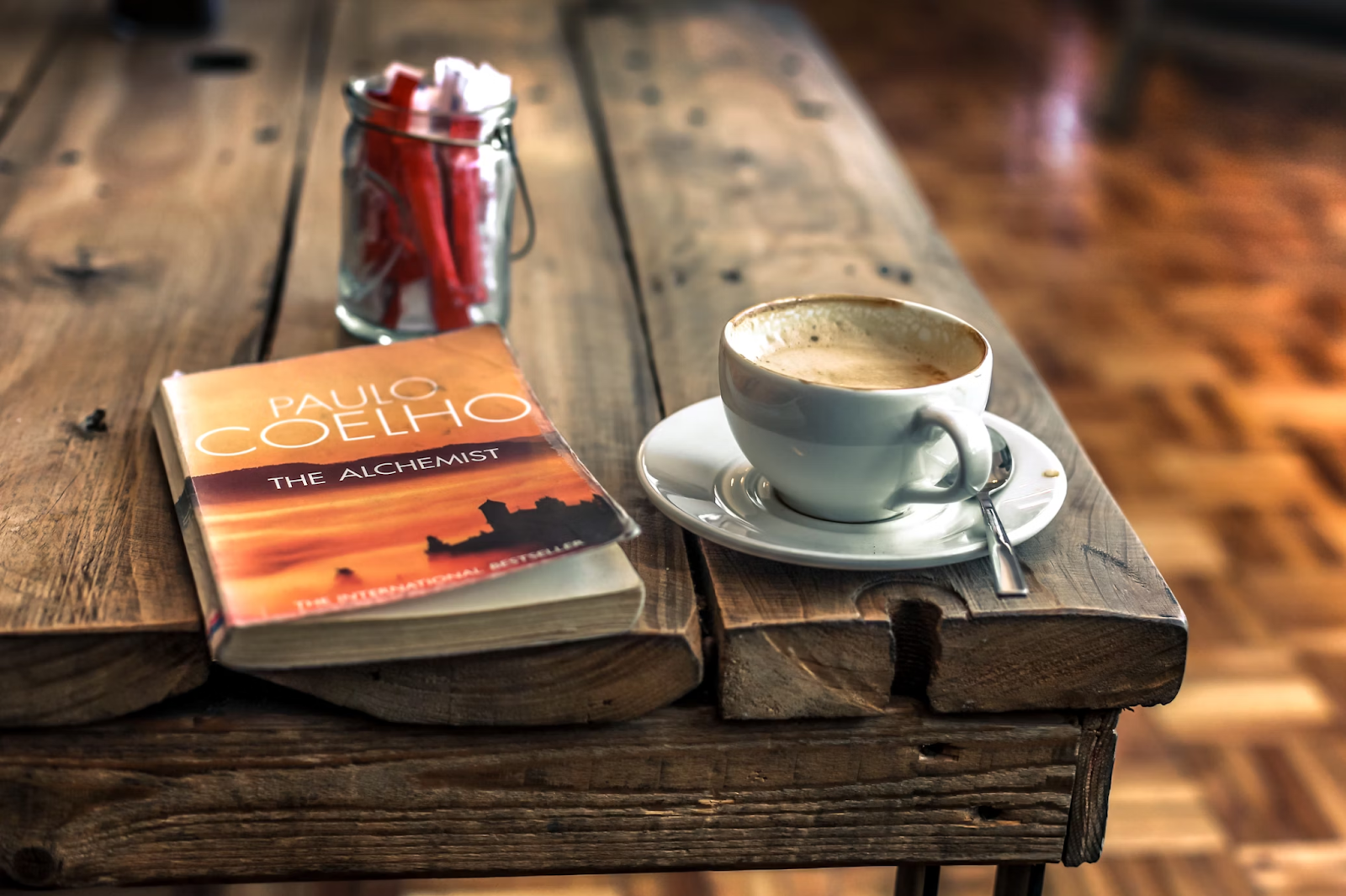 MLA short story citation example. A well-thumbed book on a real wood coffee table next to a half drunk coffee and a jar of sugar. A reader intends to use this as a citation in their academic work. 