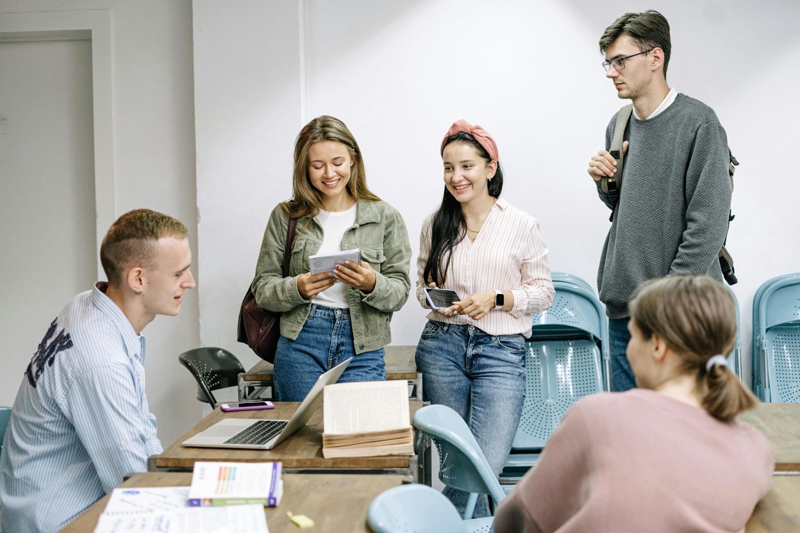 A group of female college students chatting in a class