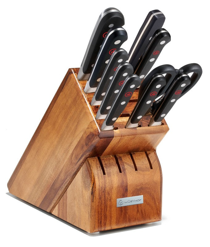 An image showing a Wusthof knife block, a well-designed storage solution for organizing kitchen knives. The block is crafted from high-quality wood, with slots that accommodate various types of knives and kitchen tools.