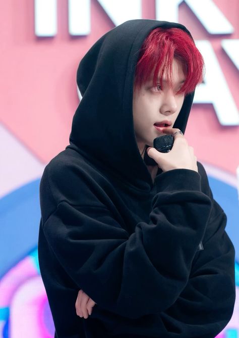 This  contain an image of Yeonjun  with red hair wearing a black cloth 