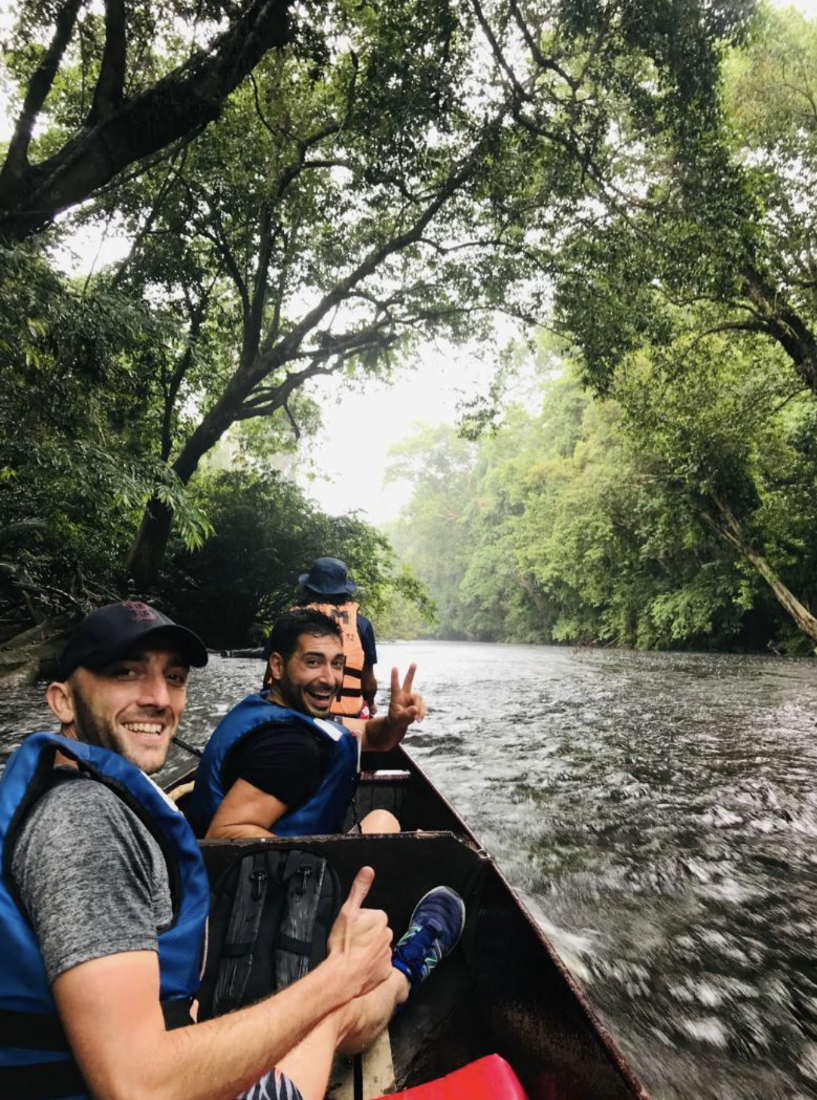 A group of men in a boat on a river

Description automatically generated