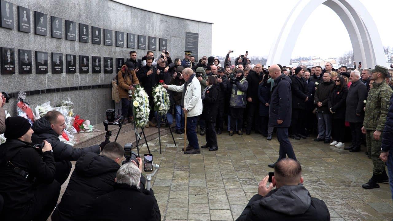 A group of people standing around a wall with Buekorps Museum in the background

Description automatically generated