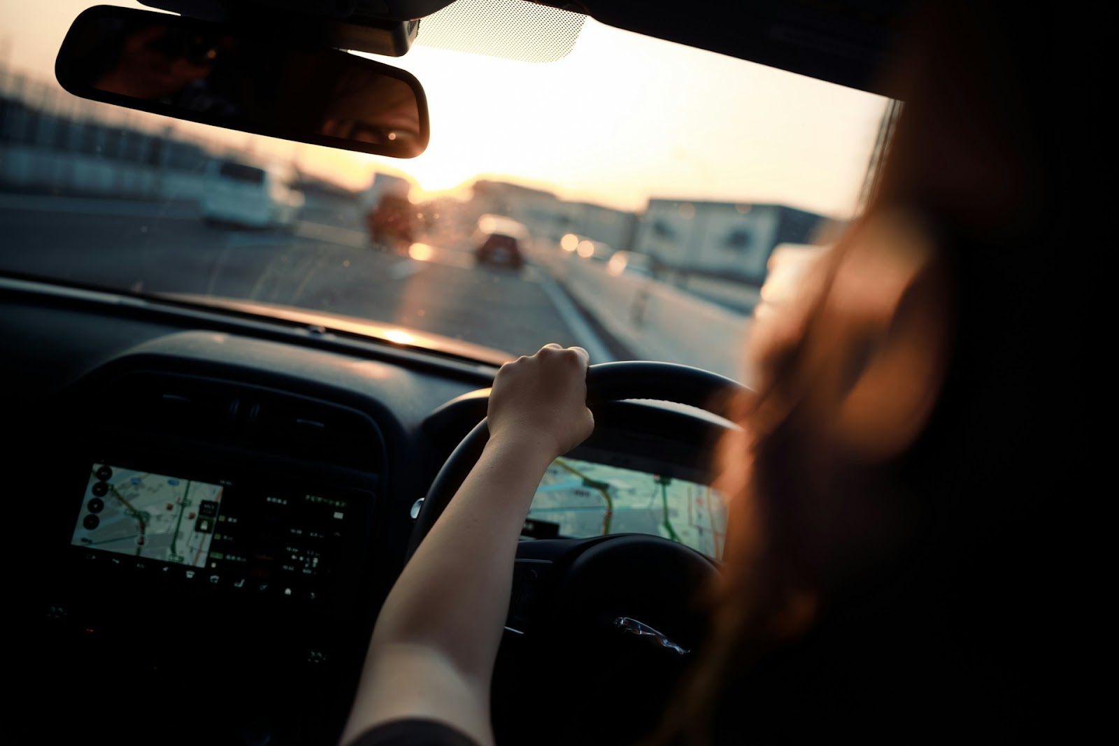 Close-up shot of a woman driving a car | Source: Unsplash