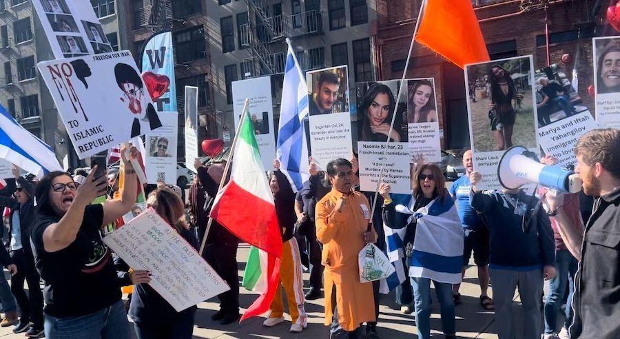 Iranian community leader Homerira Bakhiari speaks at Occidental Park.