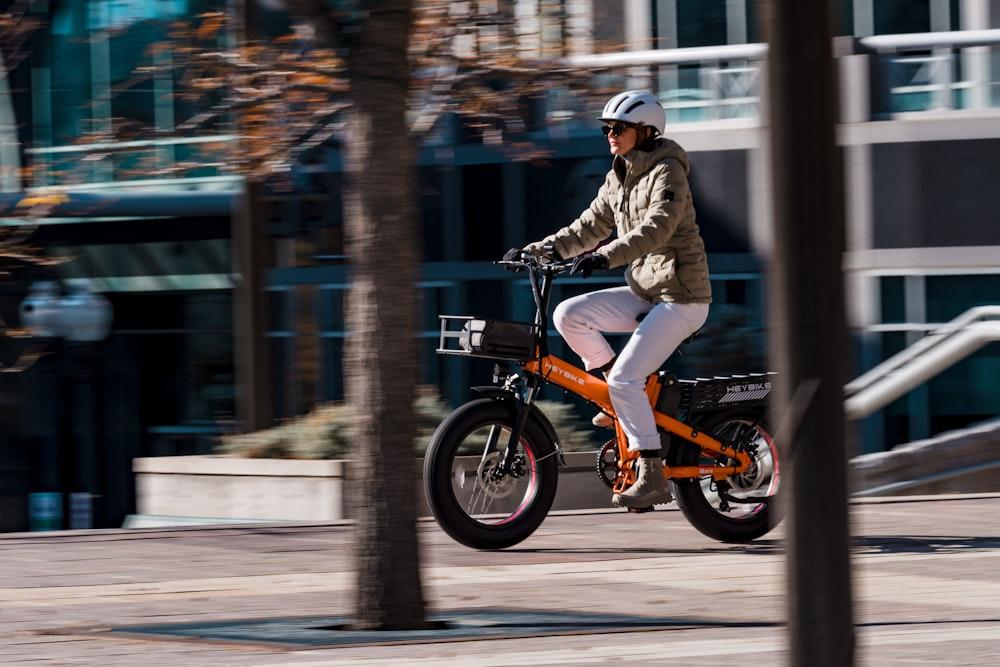 a man riding a small bike on a city street