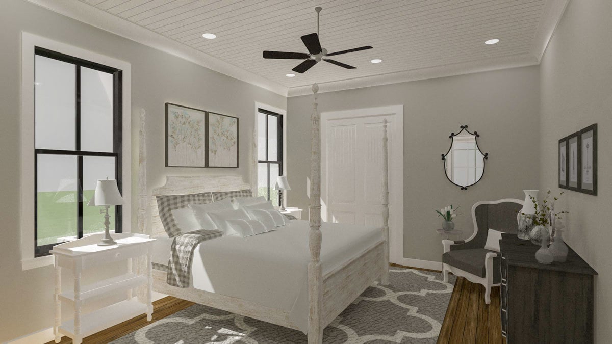 Primary bedroom with a four-poster bed, white nightstands, and framed windows.