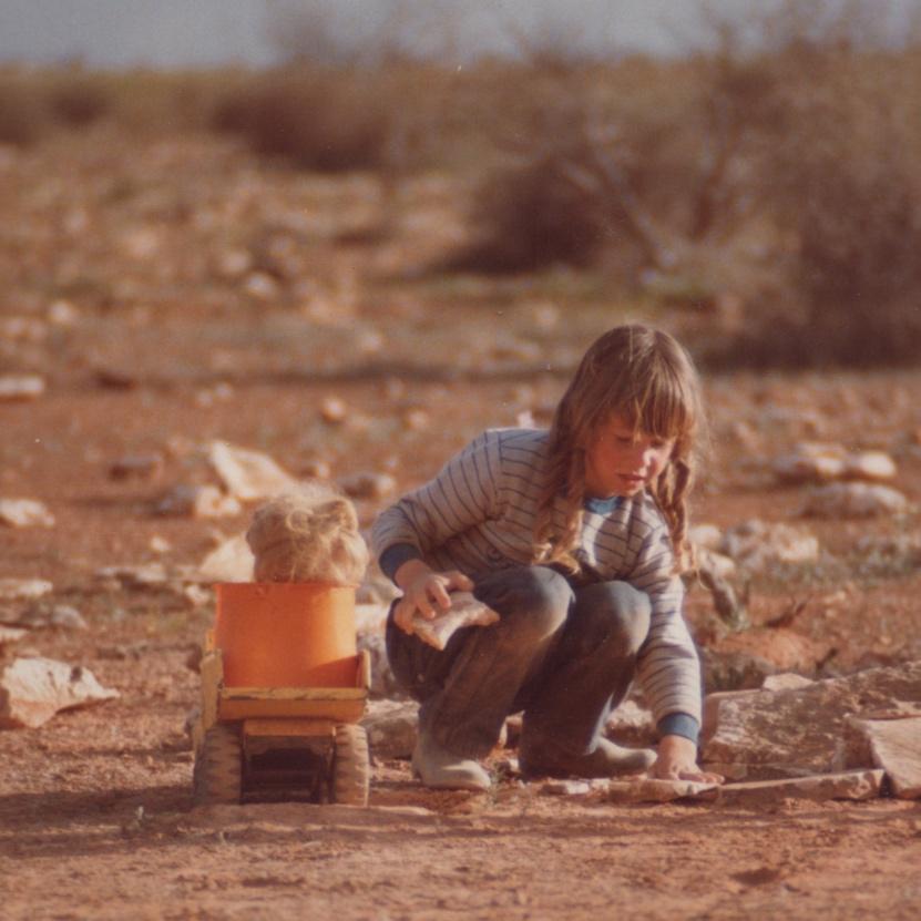 A child playing with a toy truck

Description automatically generated