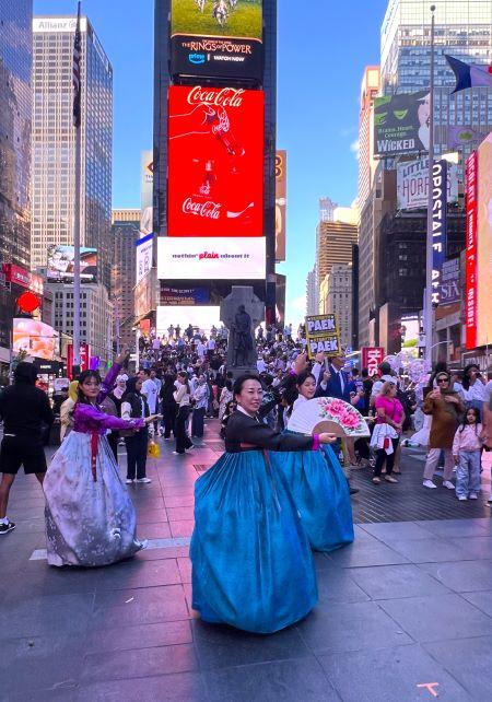 A person in blue dress in a city

Description automatically generated