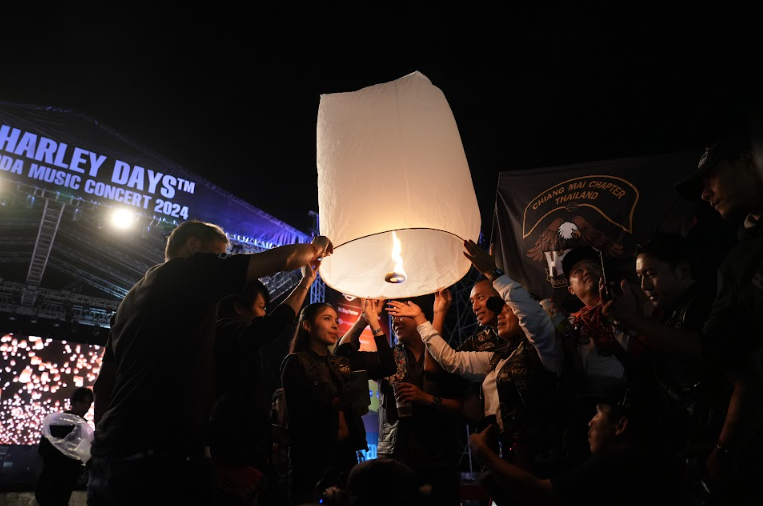 A group of people holding up a lantern

Description automatically generated