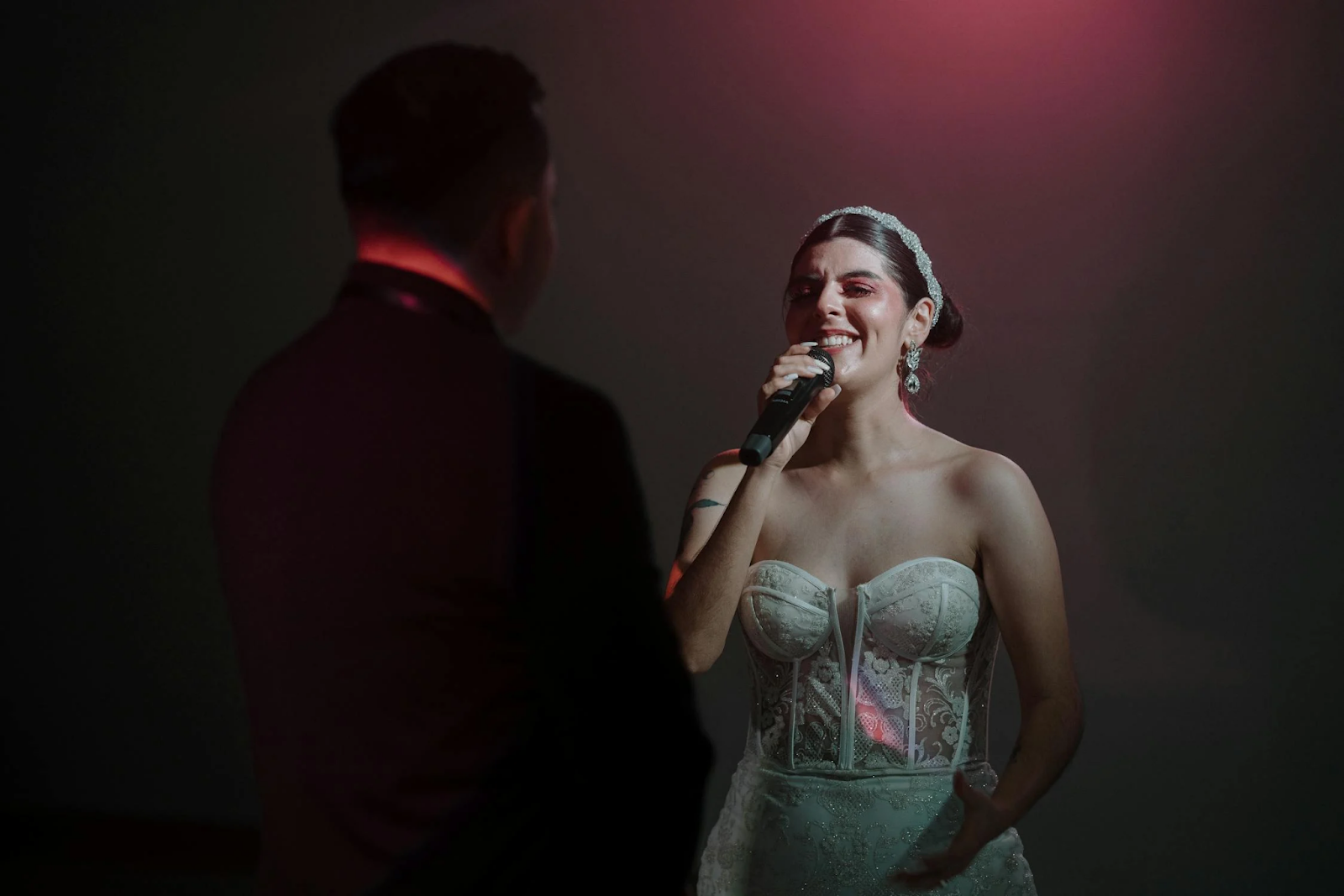 Bride singing to the groom during the wedding reception