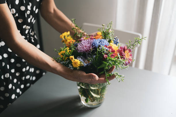 Woman arranging a bouquet of flowers