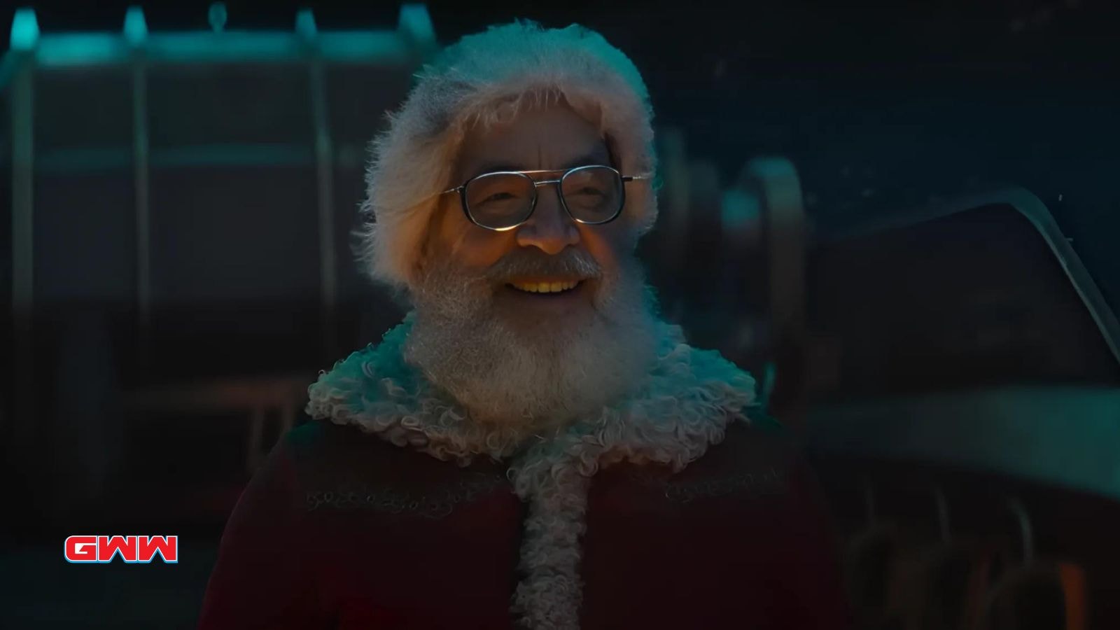 J.K. Simmons smiling as Santa Claus in Red One, standing in a room