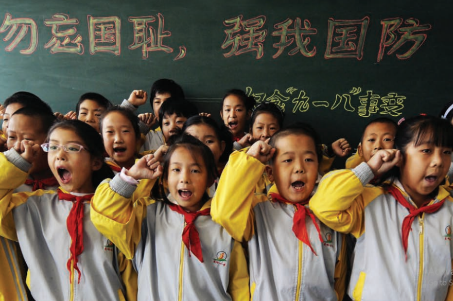 A group of children in front of a chalkboard

Description automatically generated