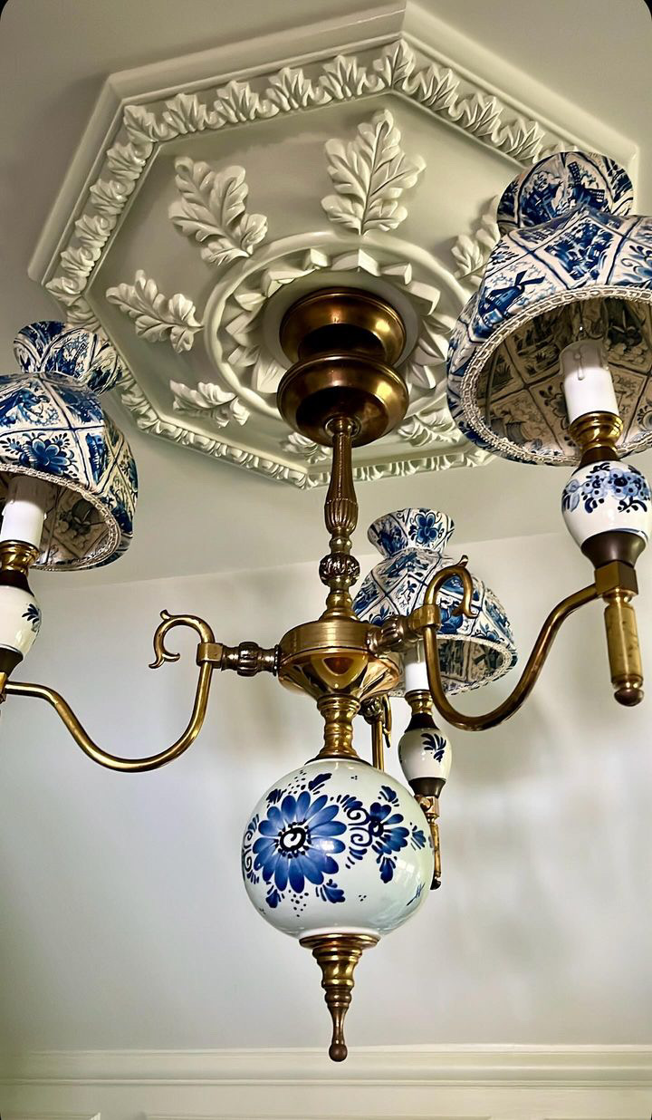 A blue and white porcelain and brass chandelier hangs from the ceiling