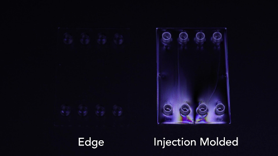 Injection molded and Edge compression-molded parts imaged in unfiltered and polarized light, showing the near-complete lack of birefringence-related artifacts available with Edge plastic parts. In the injection molded part, optical artifacts are visible in both imaging formats.