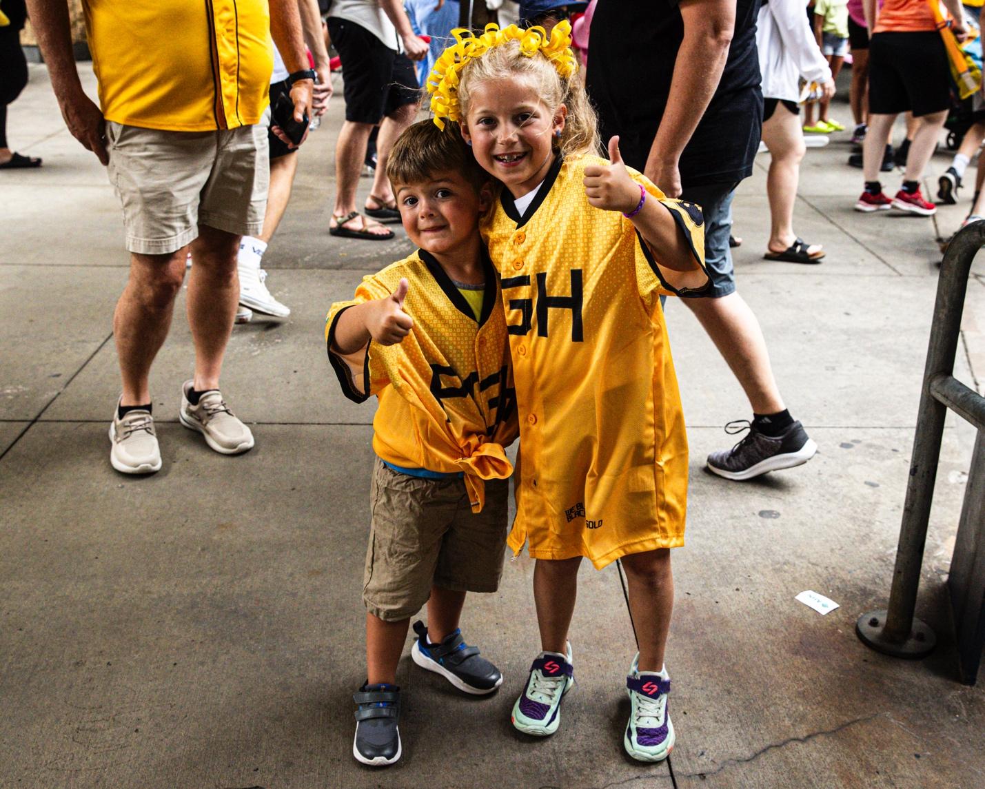 A child and child in yellow shirtsAI-generated content may be incorrect.