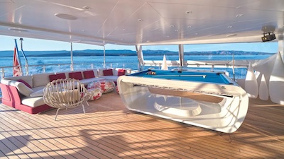 A pool table with a white cabinet on a yacht.