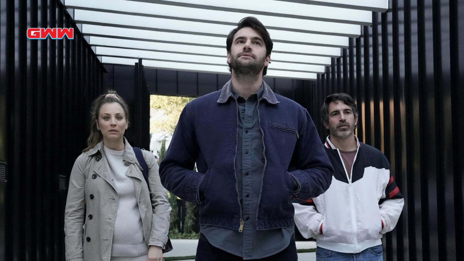 Ava, Nathan, and Matt walking through a modern hallway, looking serious and determined.