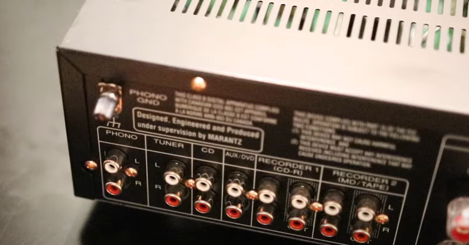 Back view of a Marantz audio receiver showing phono ground, tuner, CD, and AUX input connections.