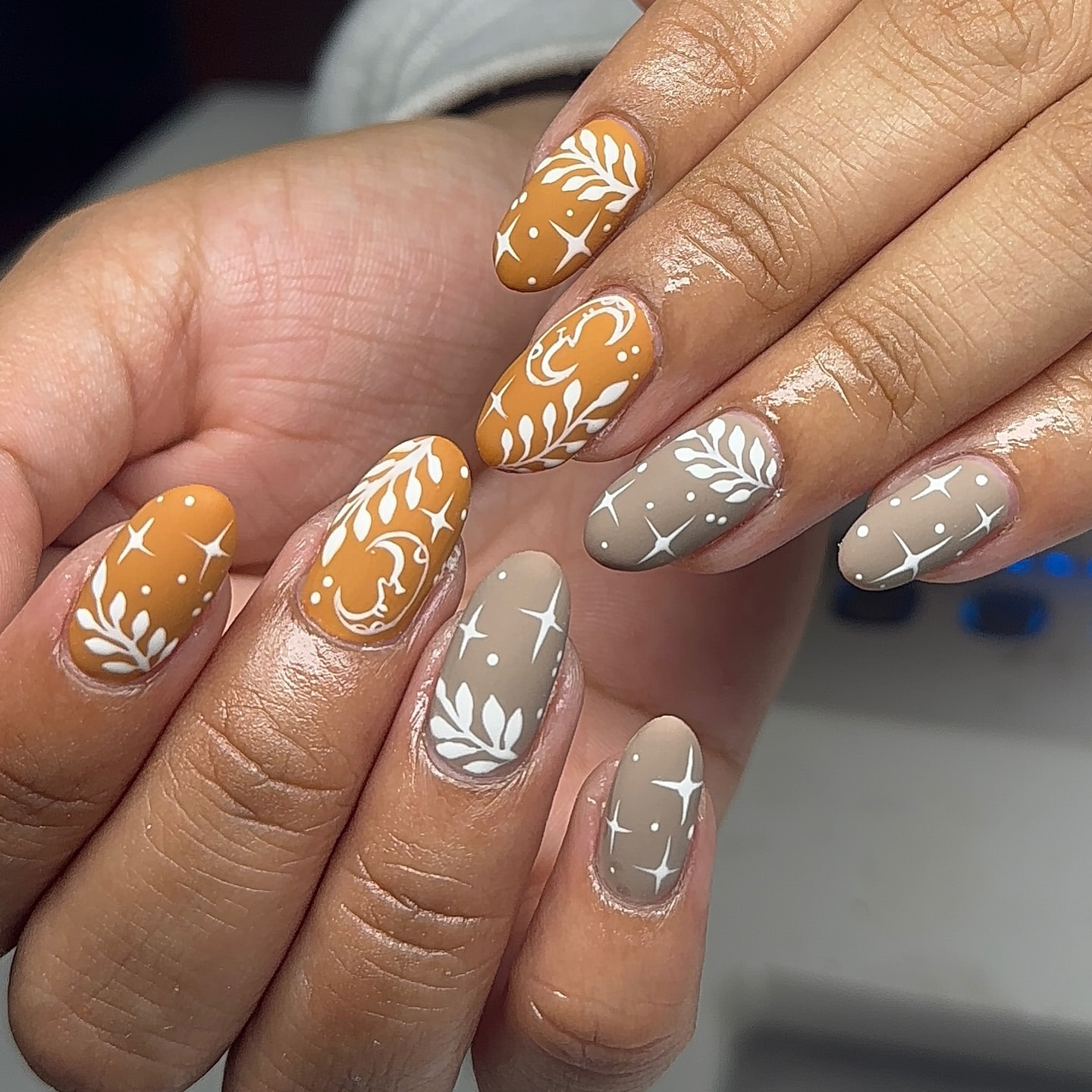 Close-up of hands with fall nail design having Leaf Cutouts