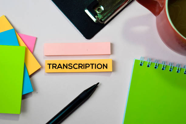 A desk with sticky notes containing transcription text, surrounded by pen, and coffee cup, as the focus shifts to top 10 online transcriptionist jobs