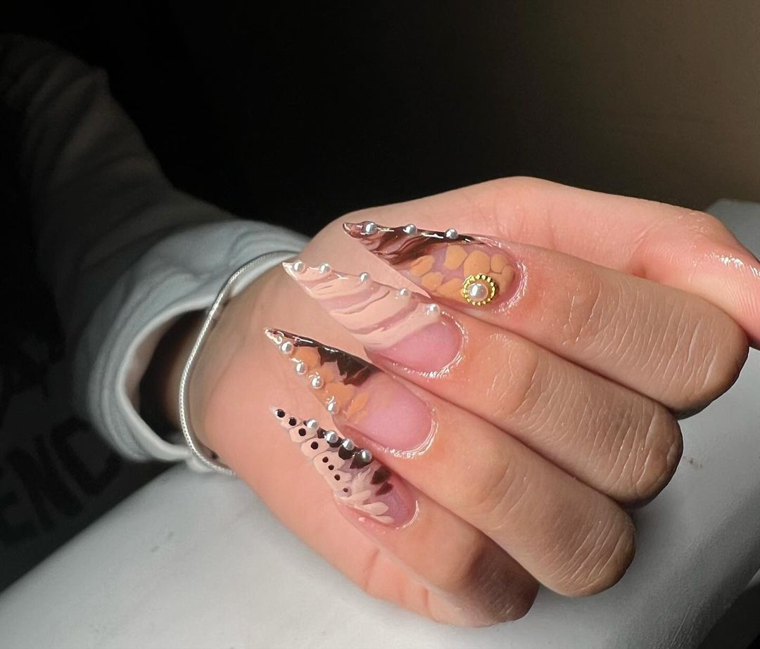 Five fingers with long, oval-shaped nails featuring a glossy ombre transition from clear to black.
