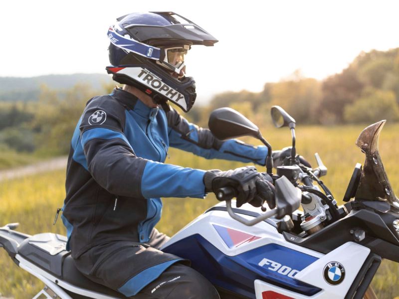 rider equipped with a BMW helmet and a BMW GS Karakum GTX set on a BMW F900GS motorcycle