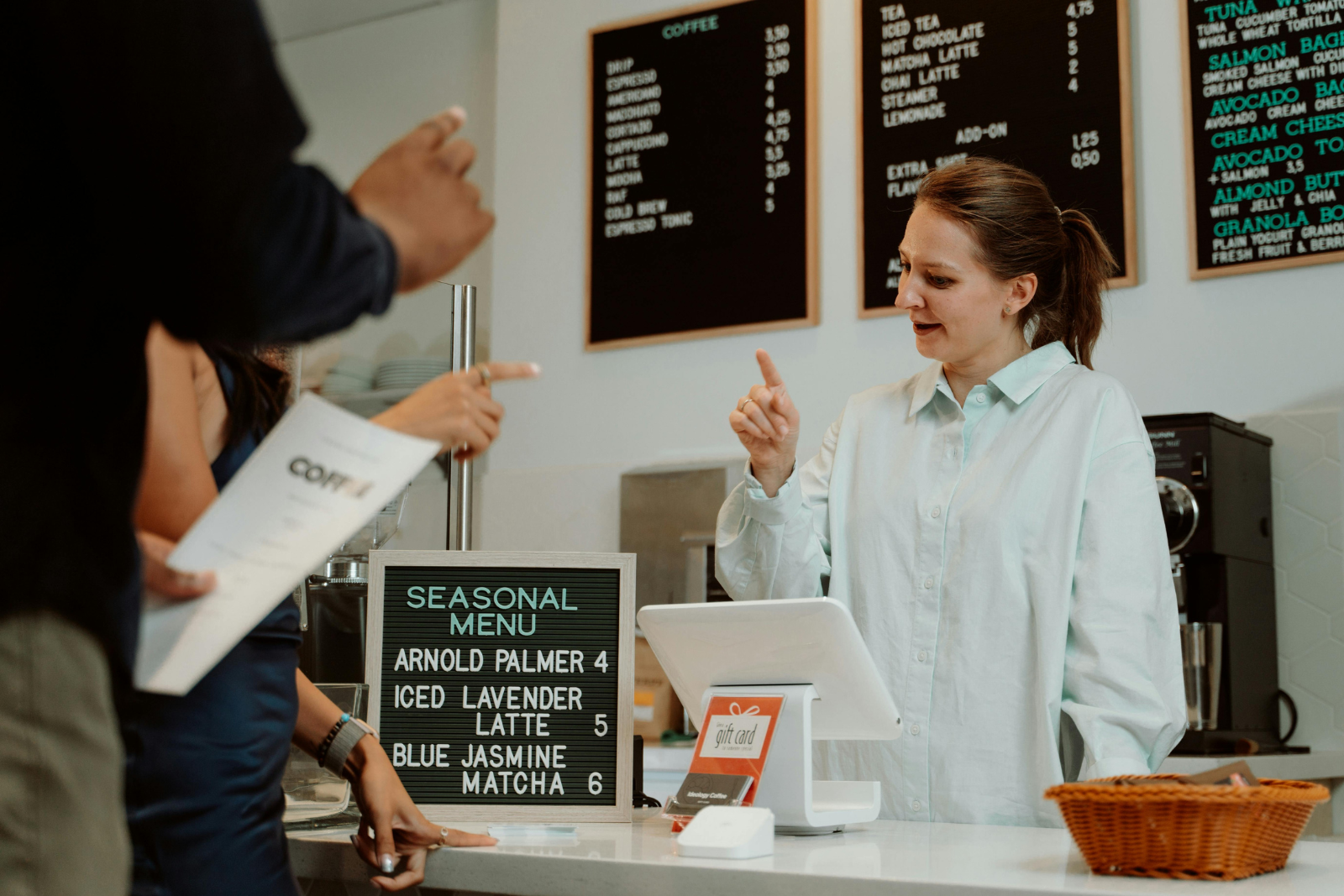 Barista talking to customers at a coffee counter