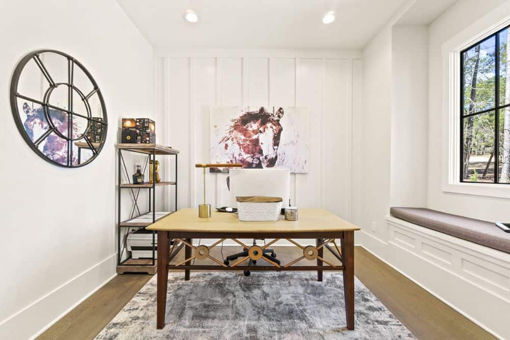 Study with a window seat, board and batten accent wall, and hardwood flooring topped with a distressed rug.Study with a window seat, board and batten accent wall, and hardwood flooring topped with a distressed rug.