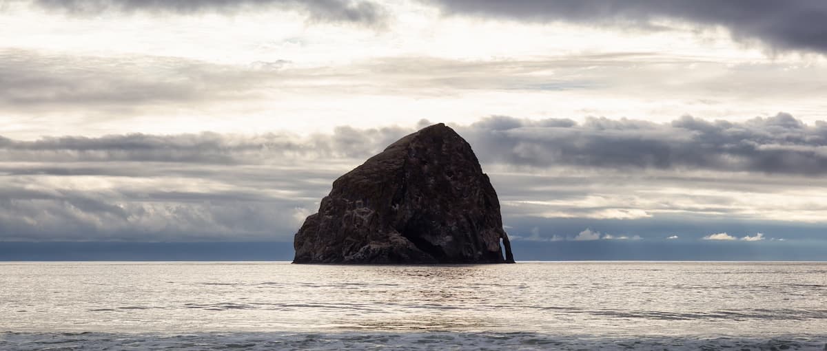 Clear view of Haystack Rock at Cape Kiwanda which is a must-visit thing to do in Spring Break 2025