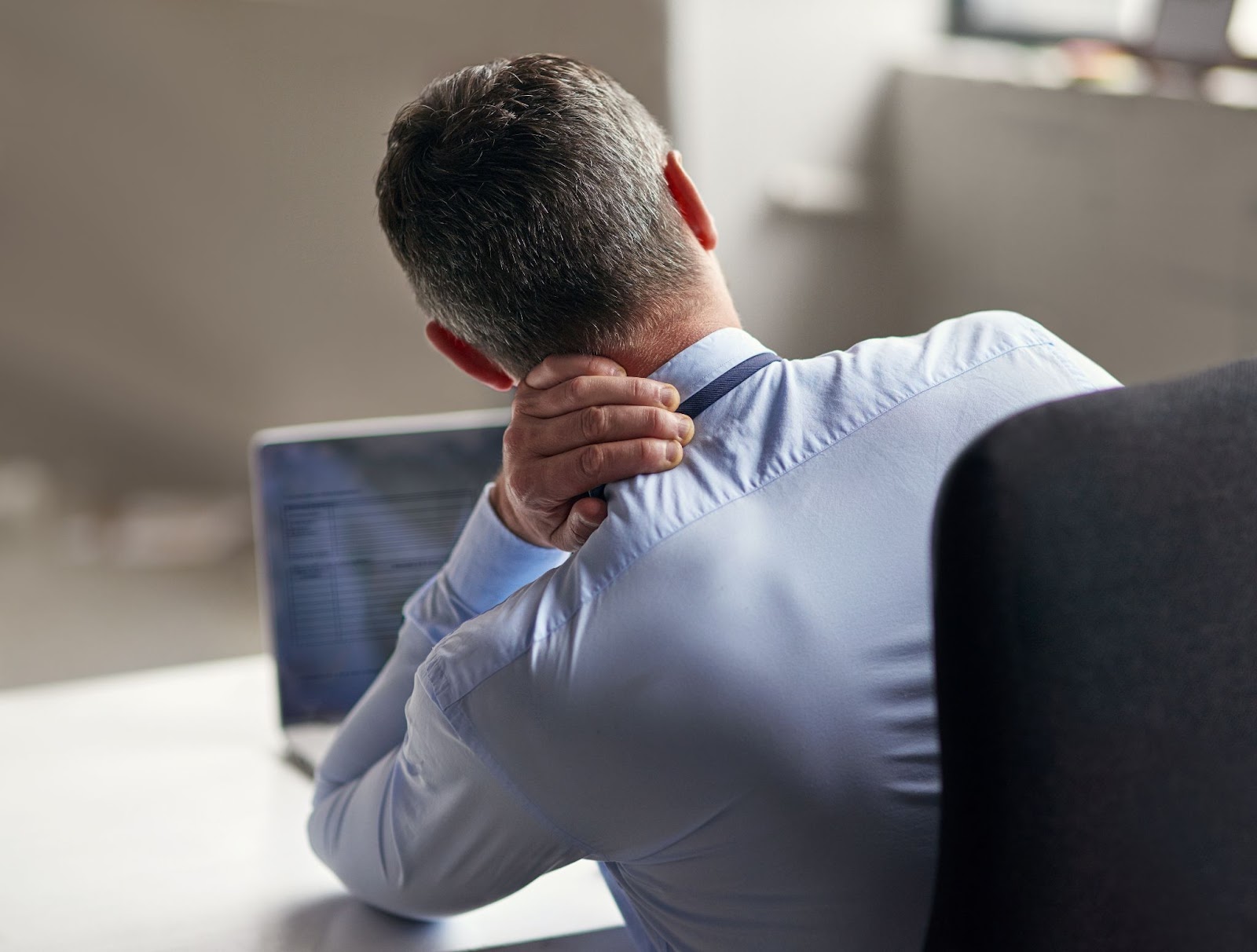 a person holding their neck to relieve tech neck symptoms.