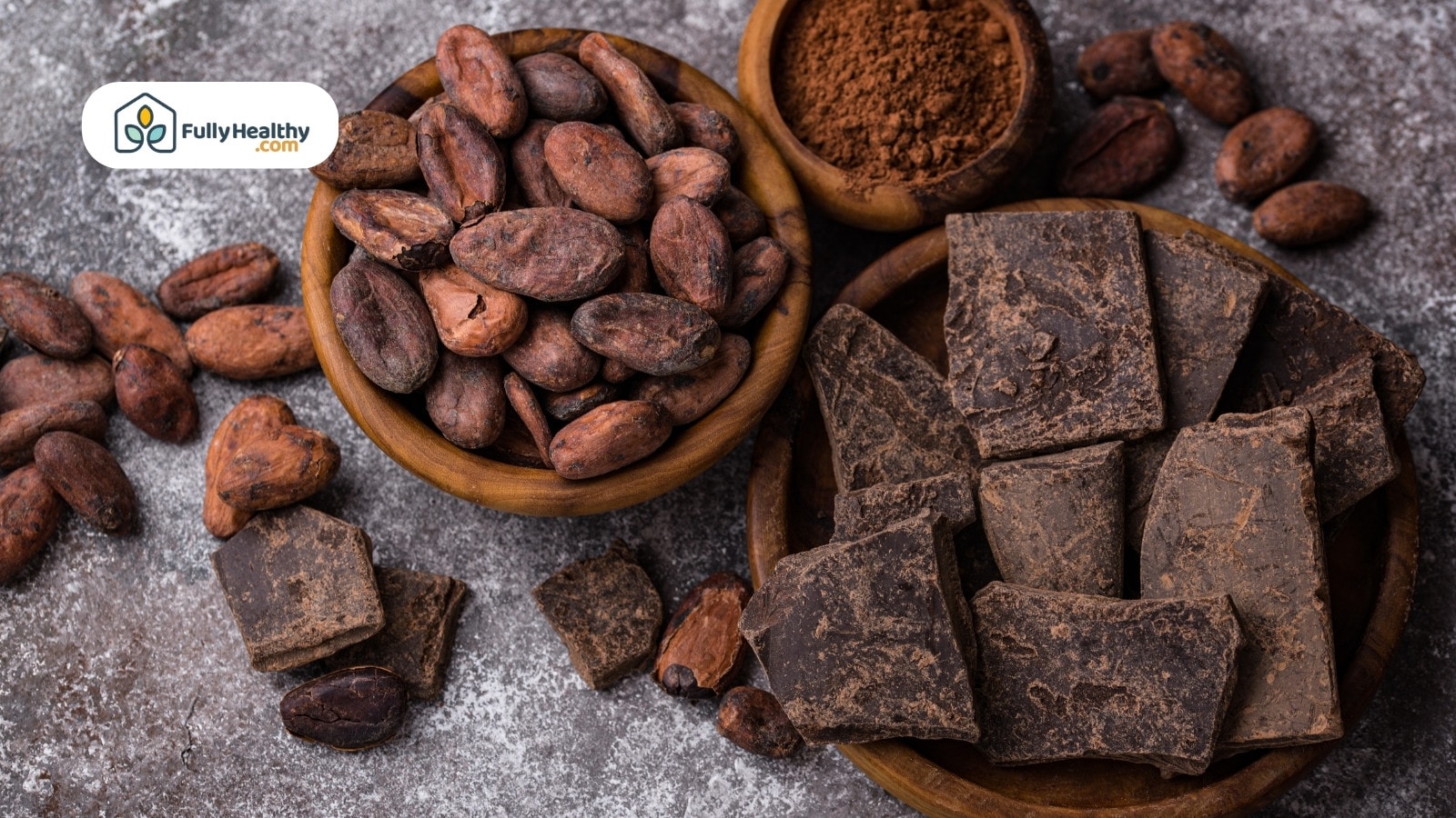 Cocoa beans powder and dark chocolate chunks on rustic background