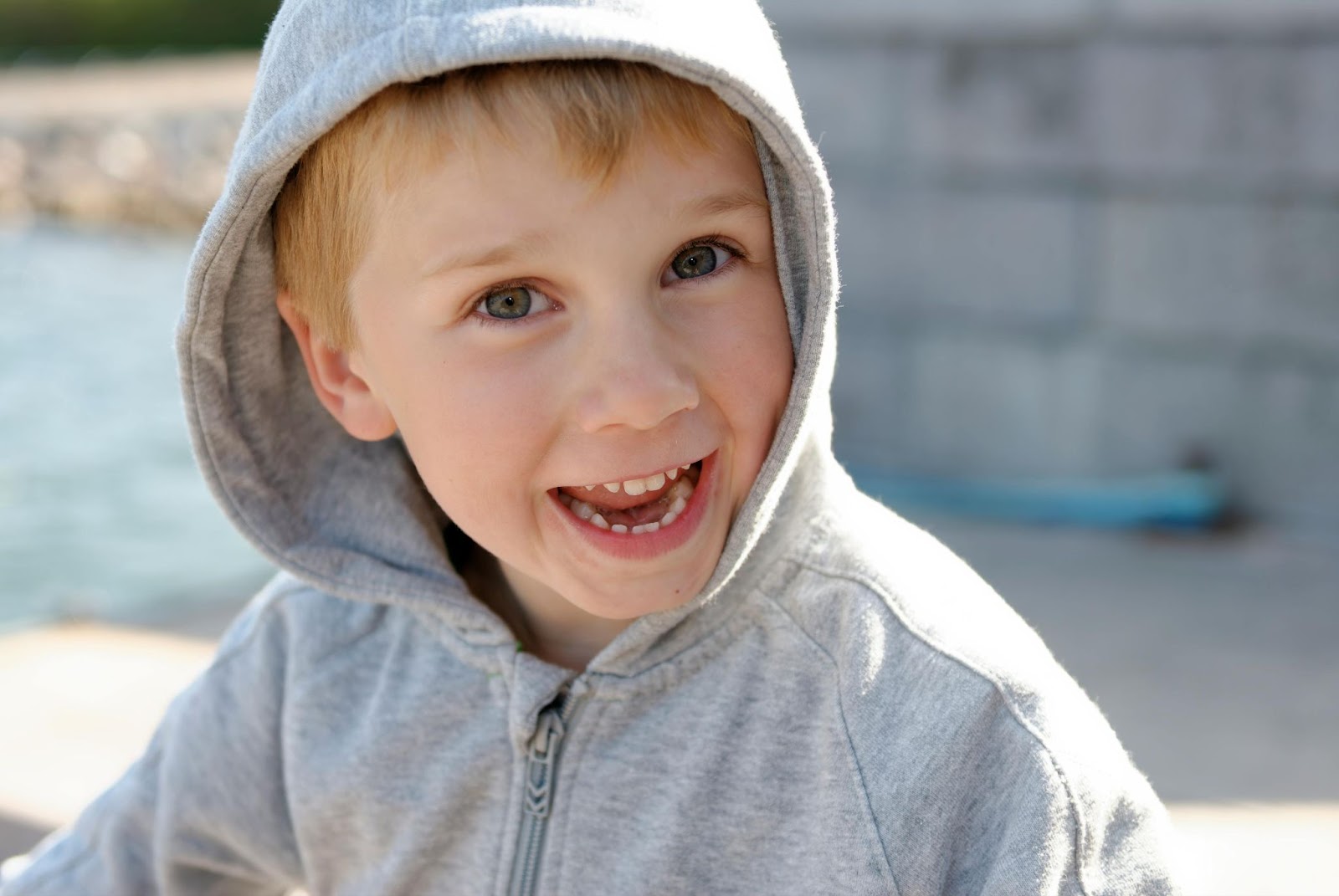 Boy in Gray Zip-Up Hoodie Smiling