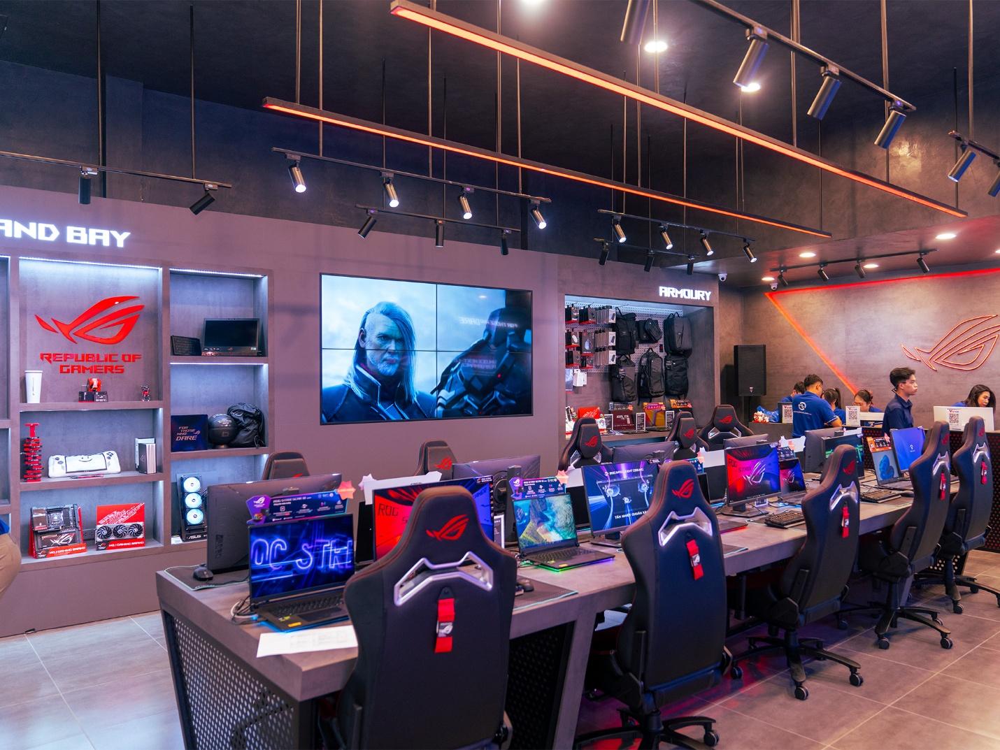 A room with many computers and a large display

Description automatically generated