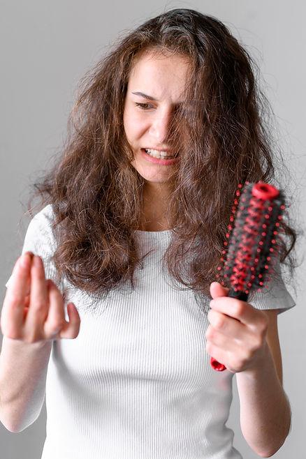 A woman holding a hairy comb