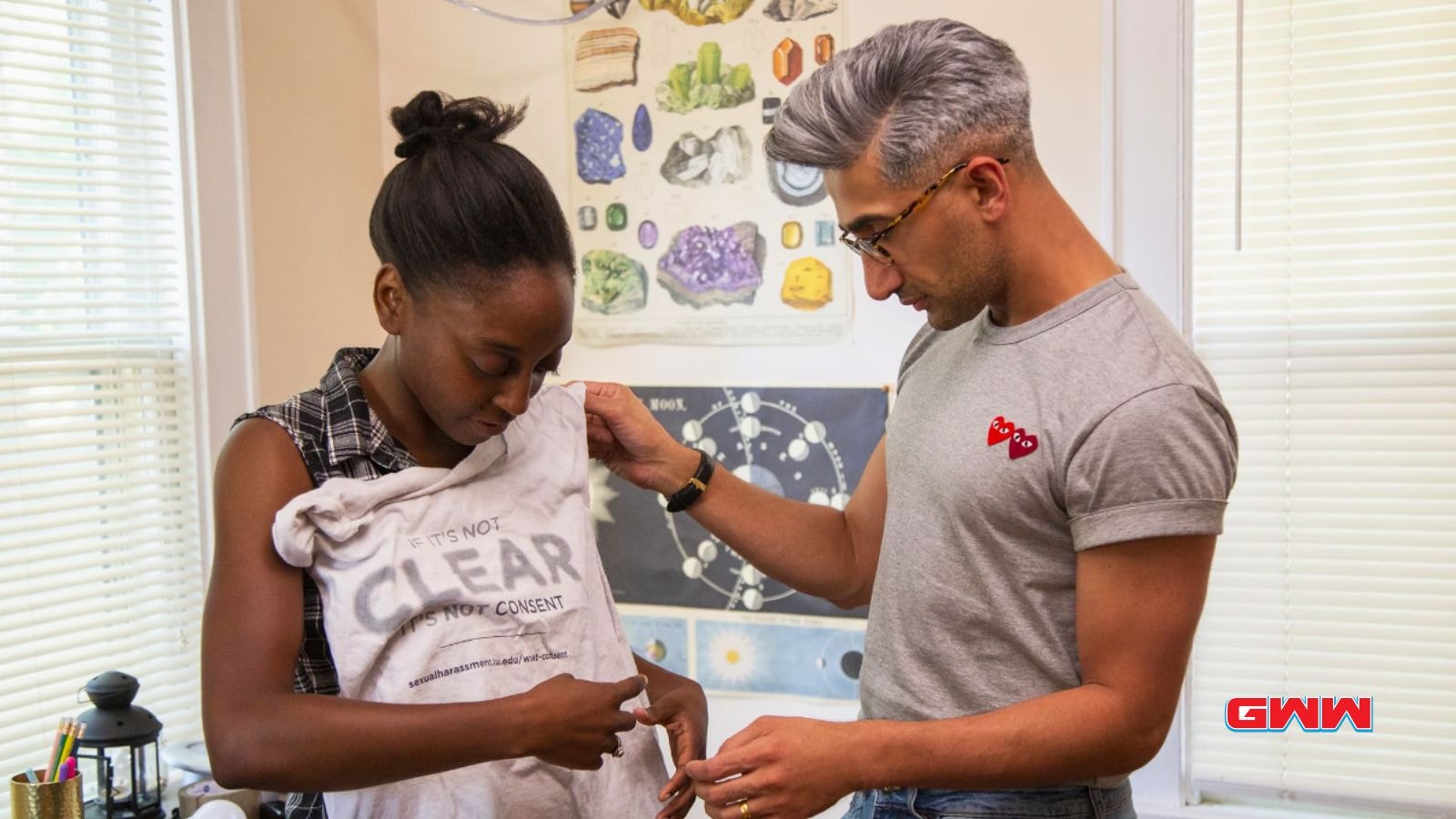 Tan France assisting a makeover hero with an inspiring fashion message on her shirt.