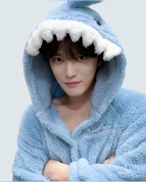 This contain Jaejoong  wearing a blue shark robe and holding his arms crossed in front of him