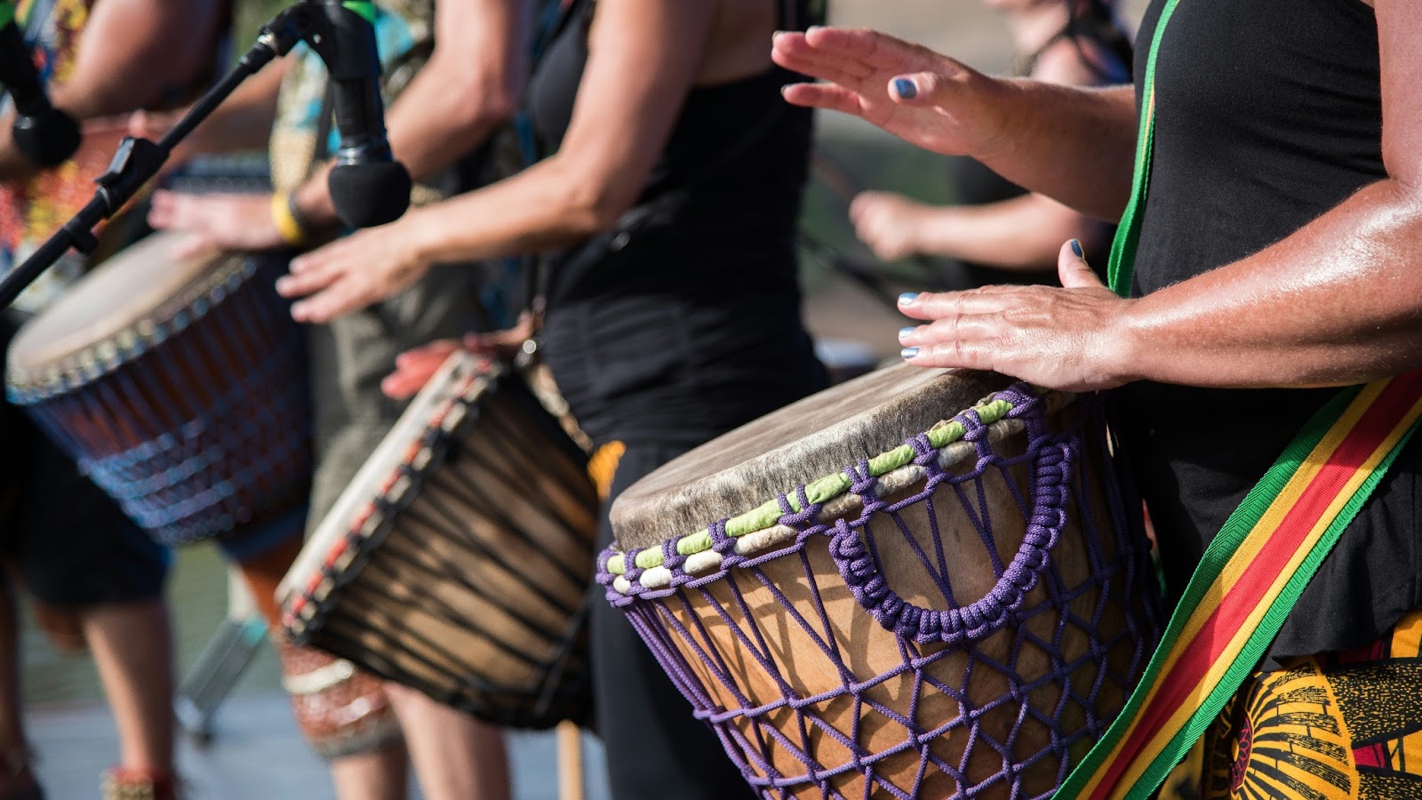 Jamaican locals playing drums filled with island vibes during a destination wedding reception. 