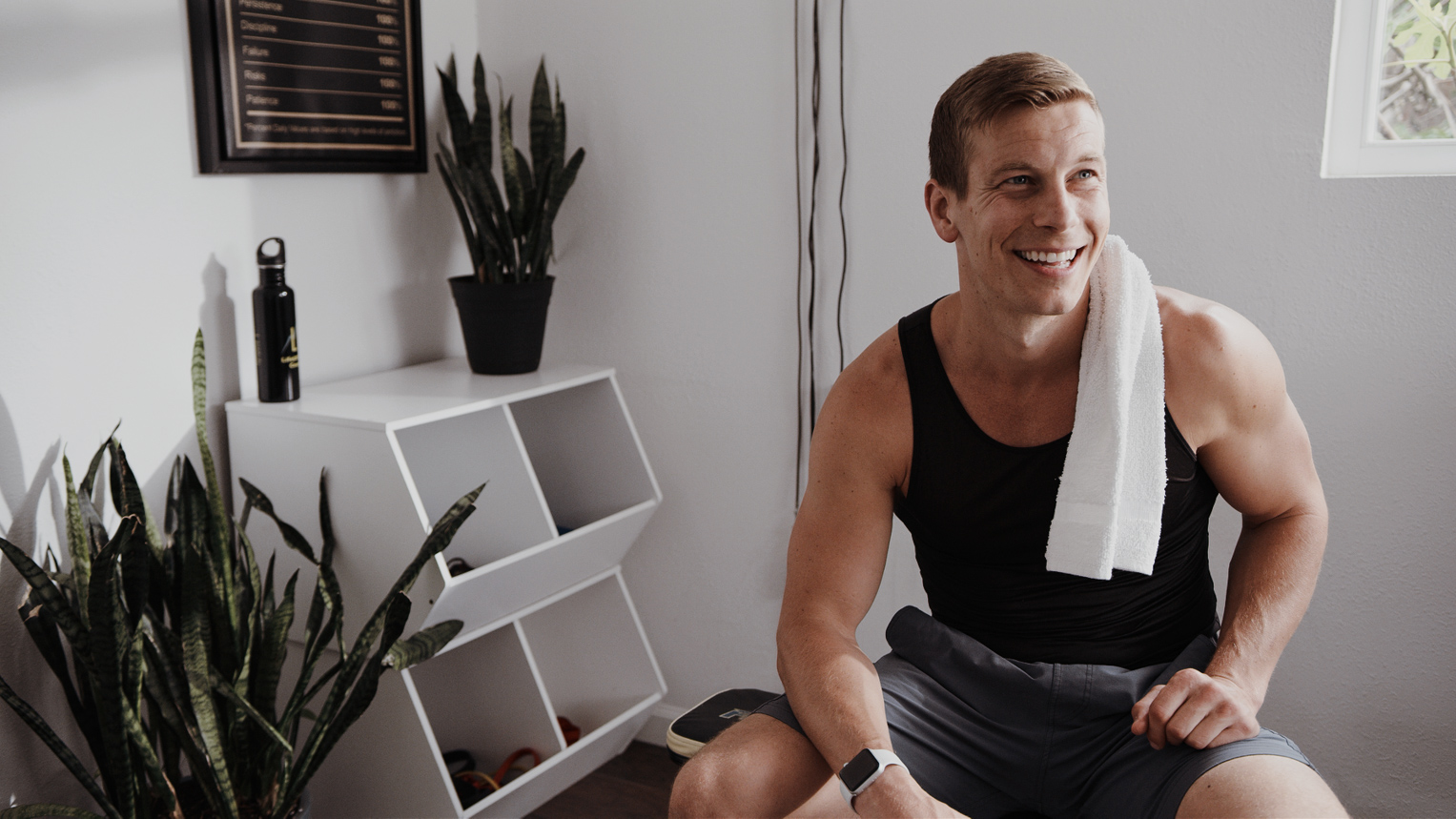 LifeUP Health Coaching LLC - Helping parents get healthy through diet, exercise and sleep. Smiling trainer with a towel.