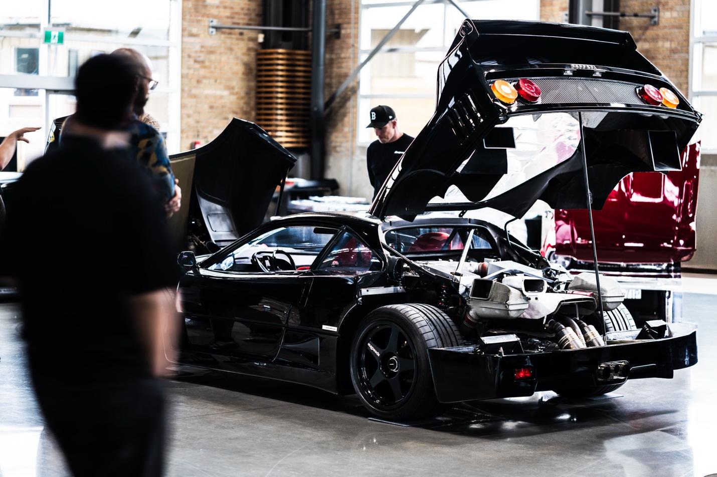 A black sports car with its hood open

AI-generated content may be incorrect.