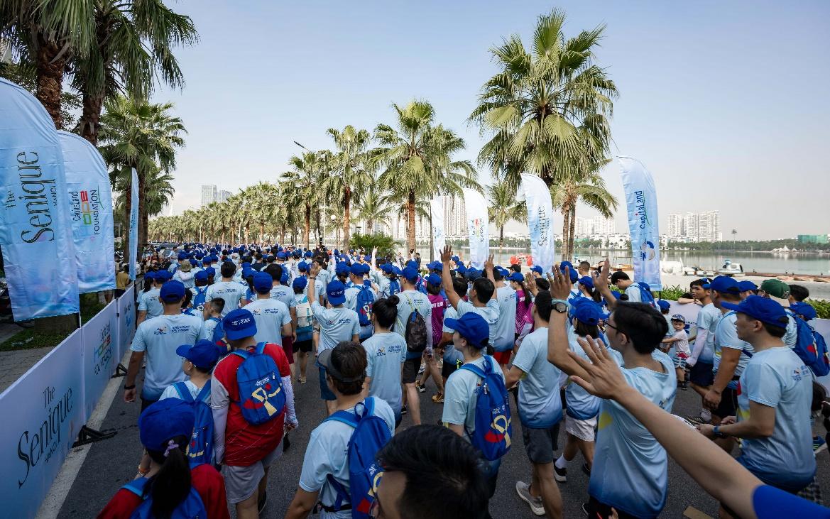 A group of people in blue shirts

Description automatically generated