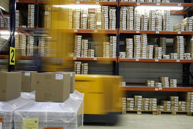 A warehouse with shelves filled with boxes, and a forklift moving products.