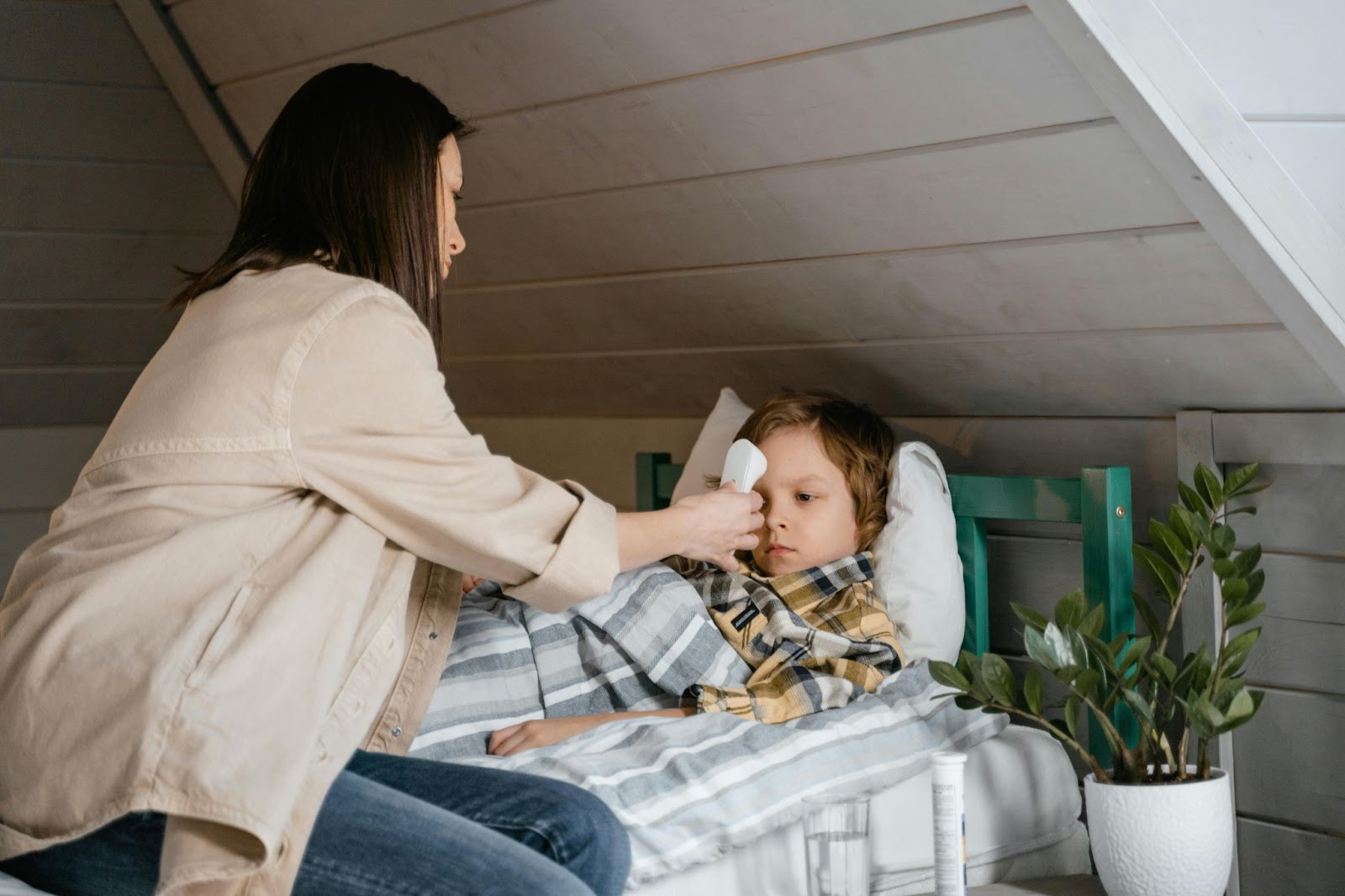 Woman Checking the Boy's Body Temperature