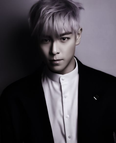 This  contain an image of  Former BIGBANG member TOP in a black jacket and white shirt