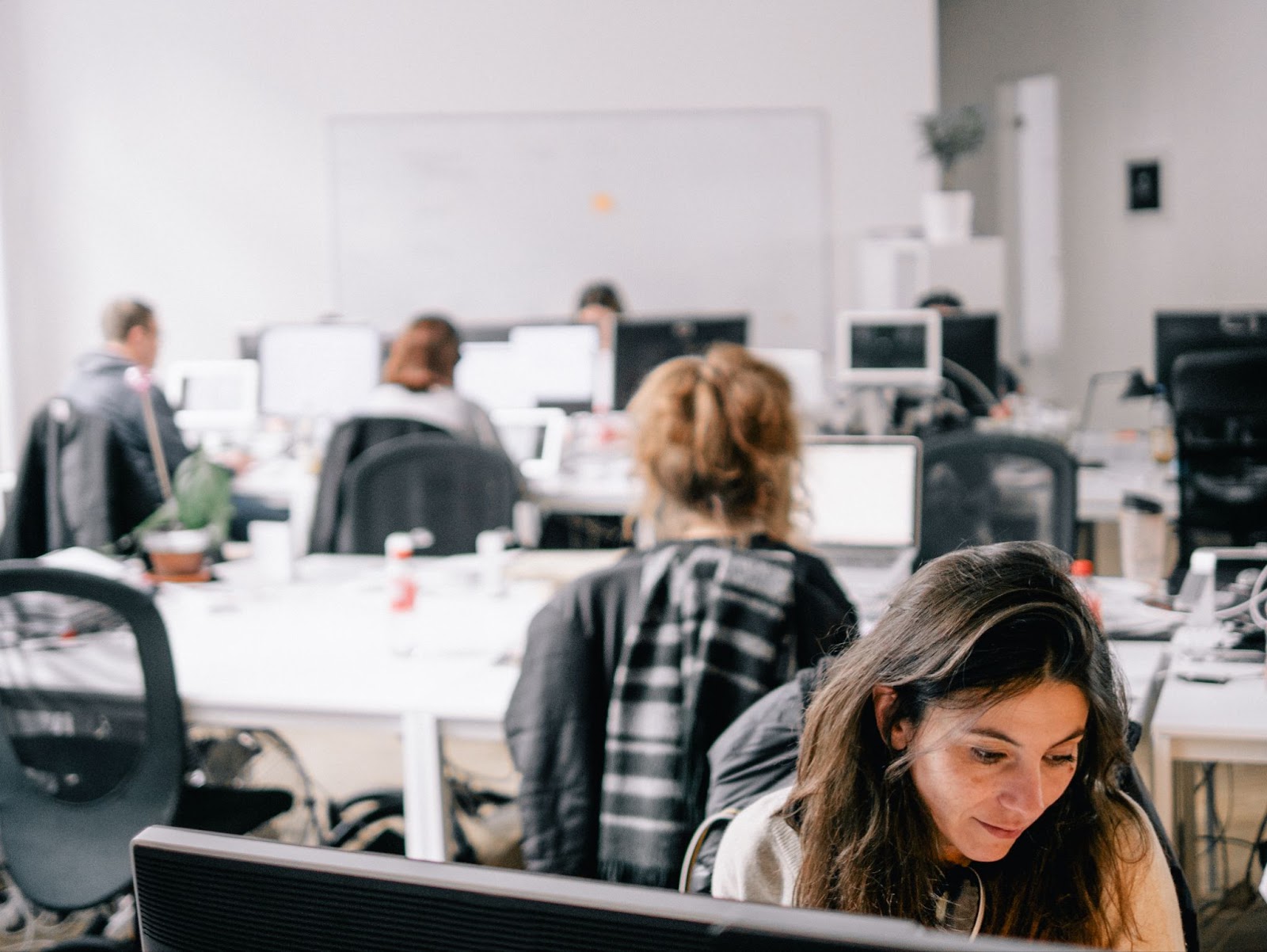 A focused employee works at an ergonomic workstation.